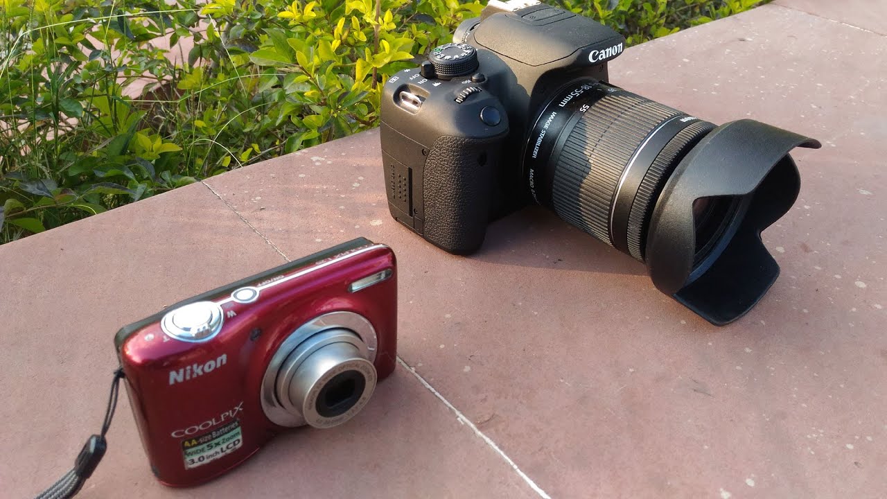 product photo of the point and shoot camera with DSLR camera on its right