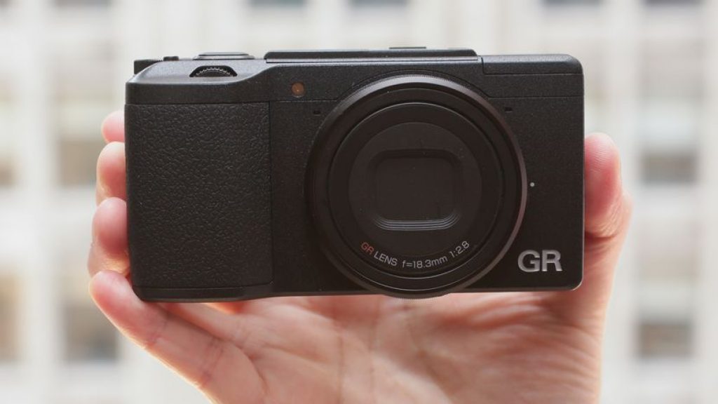 Ricoh GR II 16.2 MP Compact Digital Camera being held in one hand